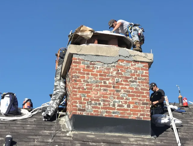 Madison Chimney Sweep installing a custom chimney crown in Madison, CT